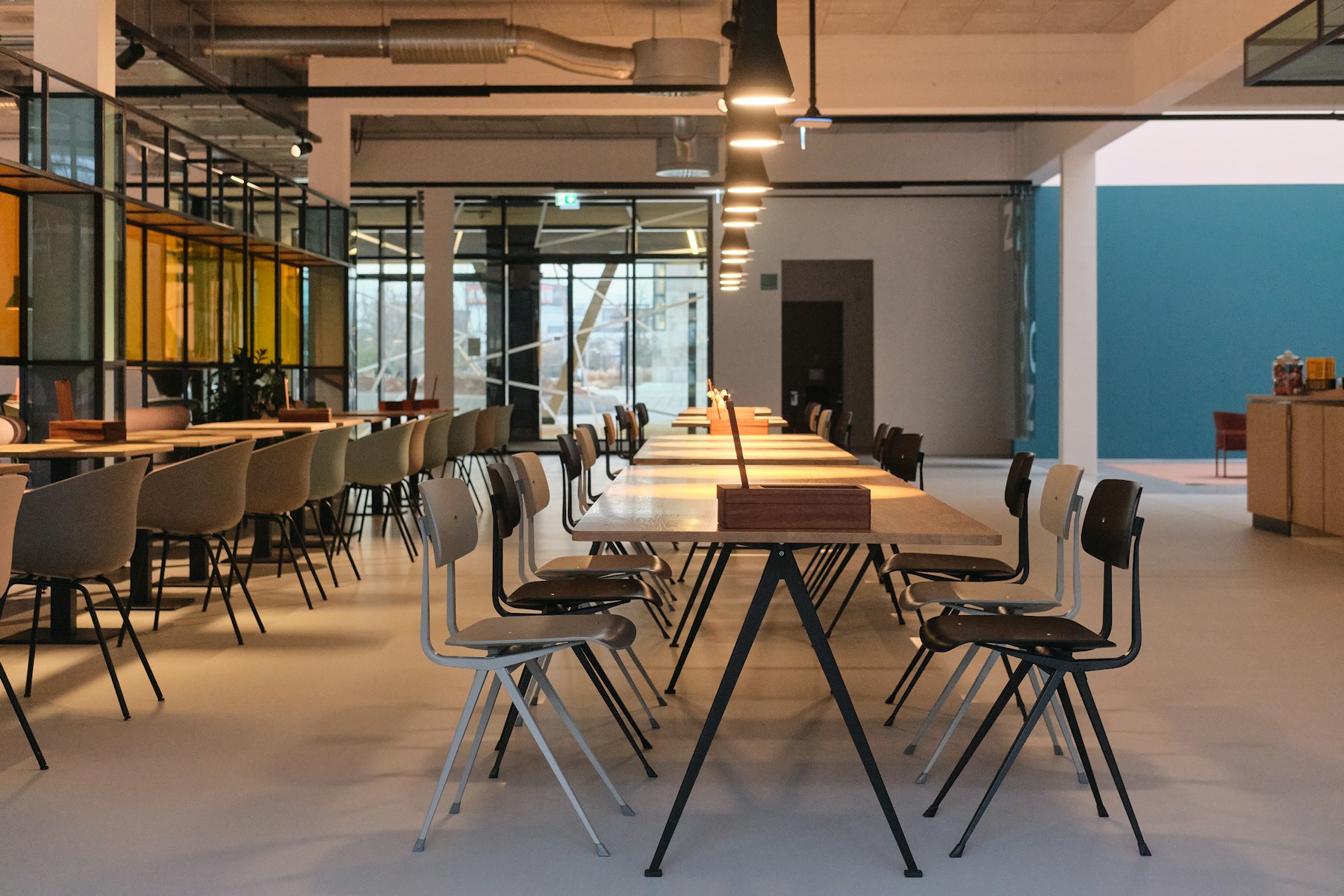An open workspace with long shared tables and warm light